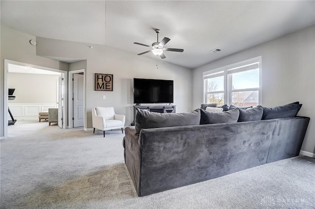 carpeted living area with ceiling fan, visible vents, and vaulted ceiling