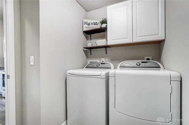 laundry room featuring cabinet space and washer and clothes dryer