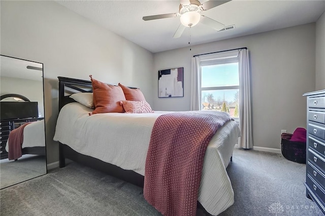 carpeted bedroom featuring visible vents, baseboards, and a ceiling fan