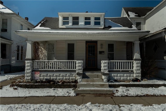 view of front of home featuring a porch and a shingled roof