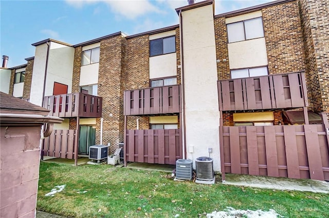 view of property featuring central AC and fence