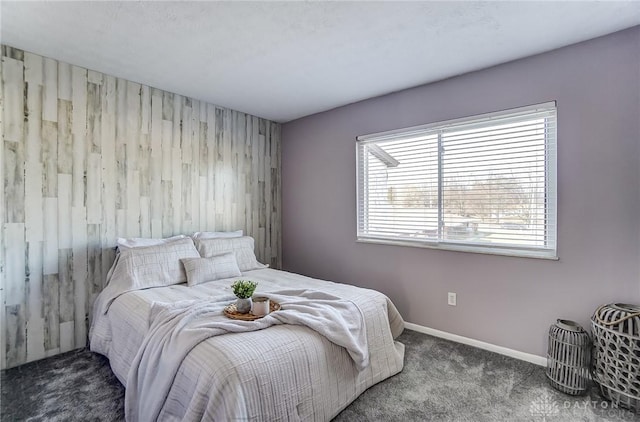 bedroom featuring baseboards and dark colored carpet