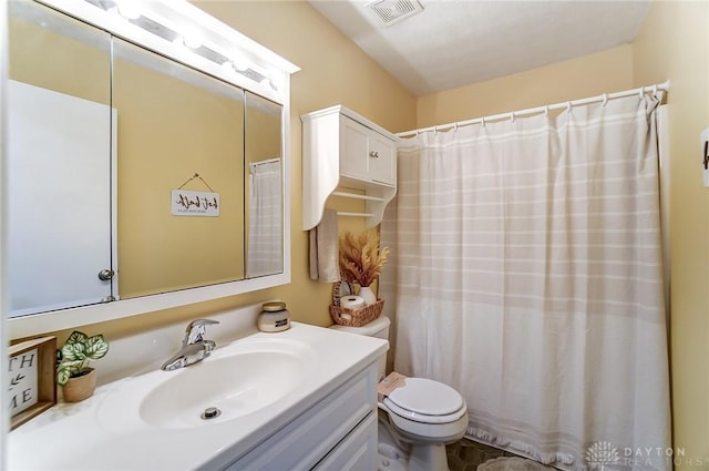 bathroom featuring toilet, vanity, visible vents, and a shower with curtain