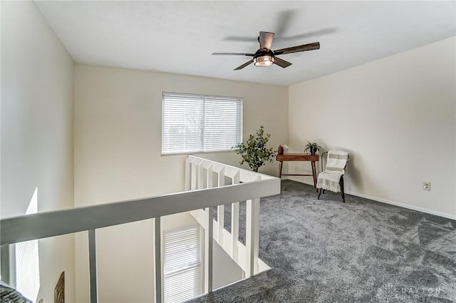 interior space with ceiling fan, carpet flooring, and baseboards