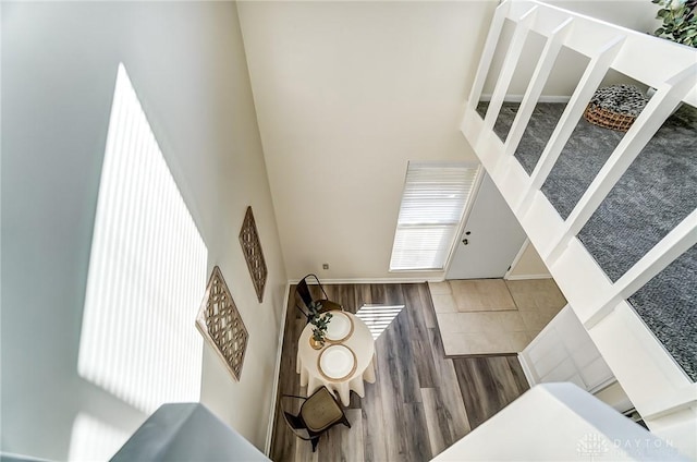 entrance foyer with a high ceiling and wood finished floors