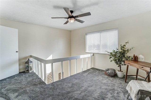 carpeted empty room featuring baseboards, visible vents, and ceiling fan