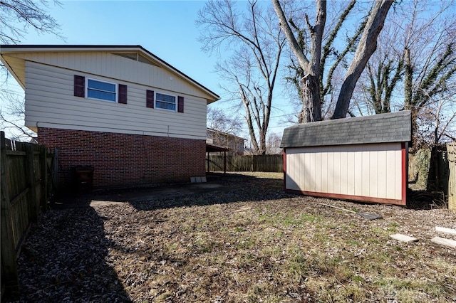 exterior space featuring an outbuilding, a shed, and a fenced backyard