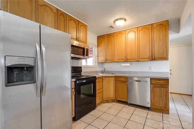 kitchen featuring visible vents, stainless steel appliances, light countertops, and light tile patterned flooring