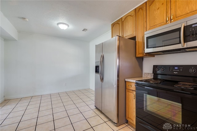 kitchen with stainless steel appliances, brown cabinetry, light countertops, and visible vents