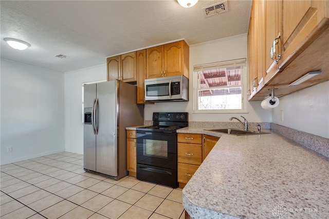 kitchen with a textured ceiling, a sink, visible vents, light countertops, and appliances with stainless steel finishes