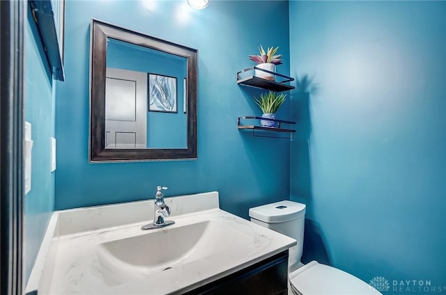 bathroom with toilet and vanity