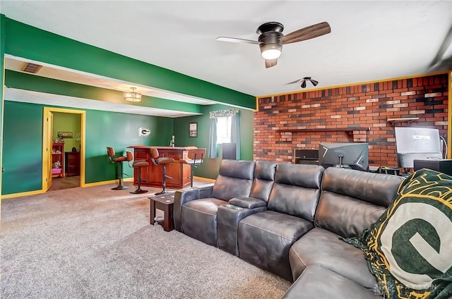 carpeted cinema room featuring baseboards, visible vents, ceiling fan, and a bar