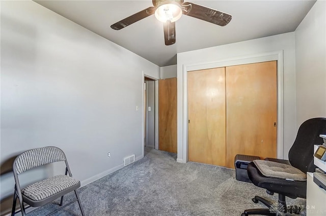 carpeted office space featuring a ceiling fan, visible vents, and baseboards