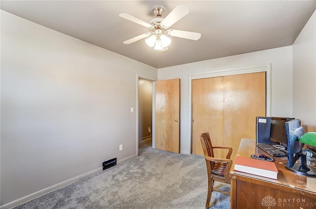 carpeted office featuring ceiling fan and baseboards