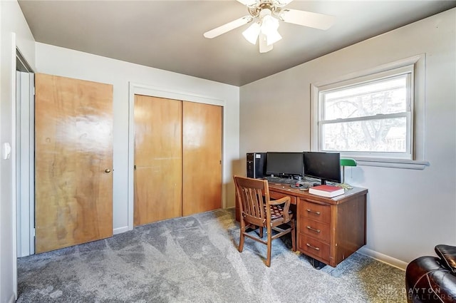 office space with light carpet, ceiling fan, and baseboards