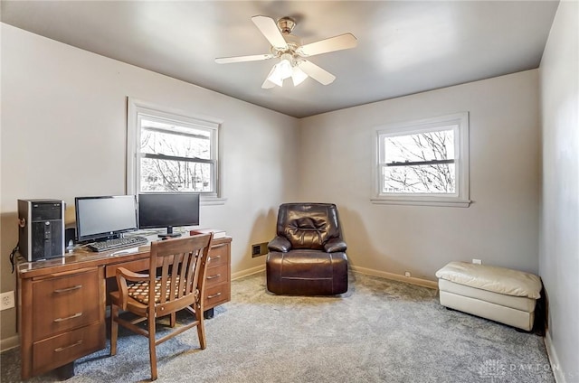 home office with baseboards, a ceiling fan, light colored carpet, and a healthy amount of sunlight