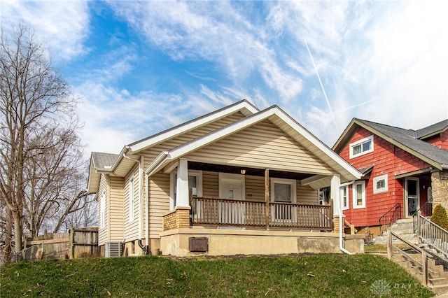 bungalow-style home with a front lawn and a porch