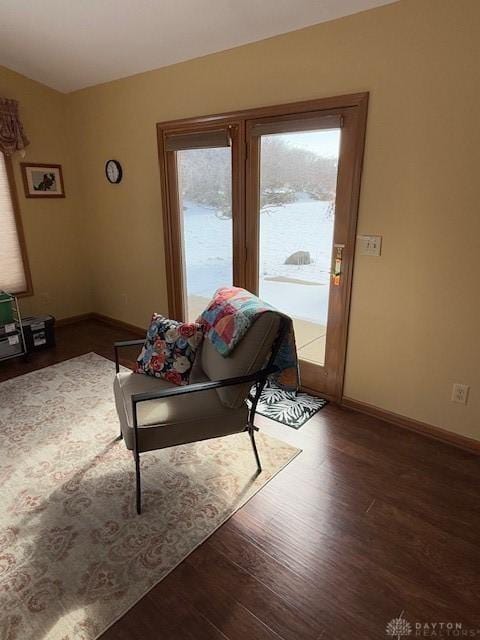 living area with dark wood finished floors and baseboards