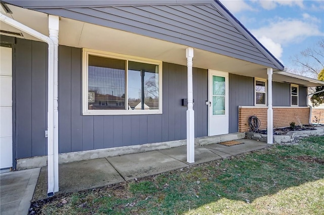 entrance to property featuring brick siding