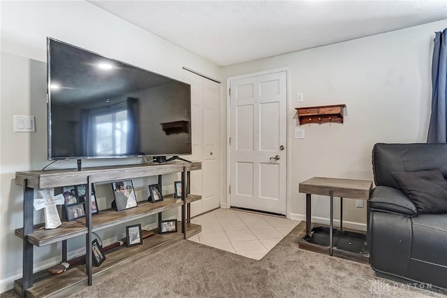 entrance foyer with light carpet, light tile patterned floors, and baseboards