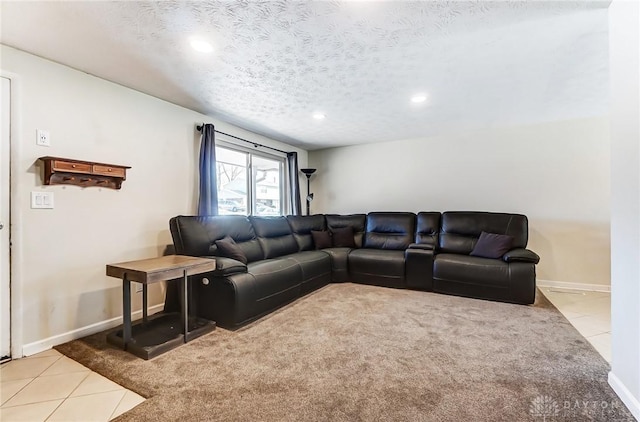 living room featuring a textured ceiling, light tile patterned floors, light colored carpet, and baseboards