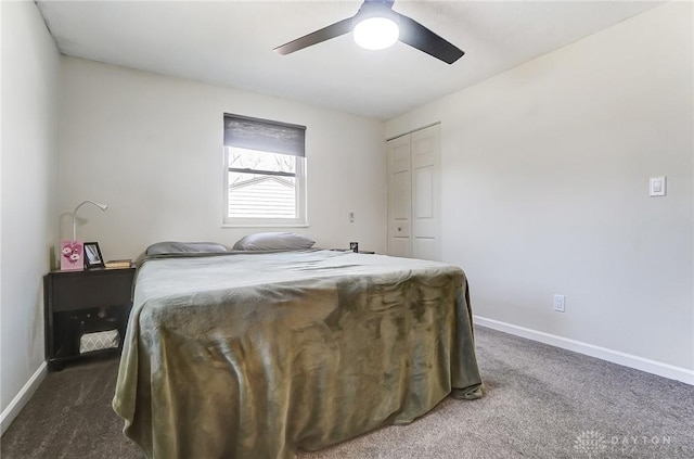 bedroom with ceiling fan, baseboards, dark colored carpet, and a closet