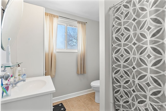 bathroom featuring a shower with shower curtain, toilet, vanity, tile patterned flooring, and baseboards