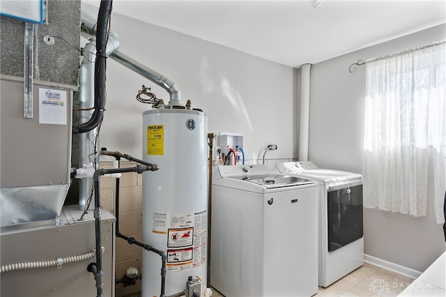 laundry area with washer and clothes dryer, heating unit, water heater, laundry area, and baseboards