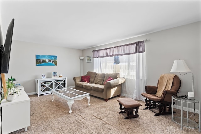 carpeted living room featuring baseboards