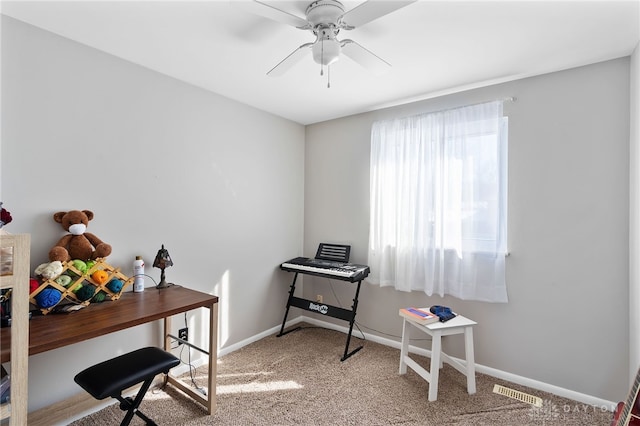 carpeted office with a ceiling fan, visible vents, and baseboards