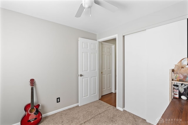 unfurnished bedroom featuring ceiling fan, a closet, carpet flooring, and baseboards