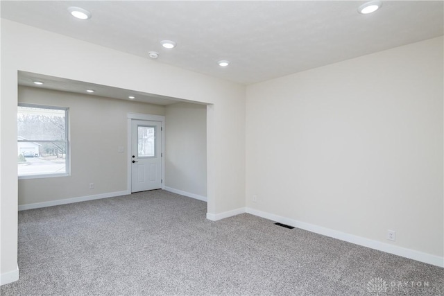 spare room with carpet, visible vents, baseboards, and recessed lighting