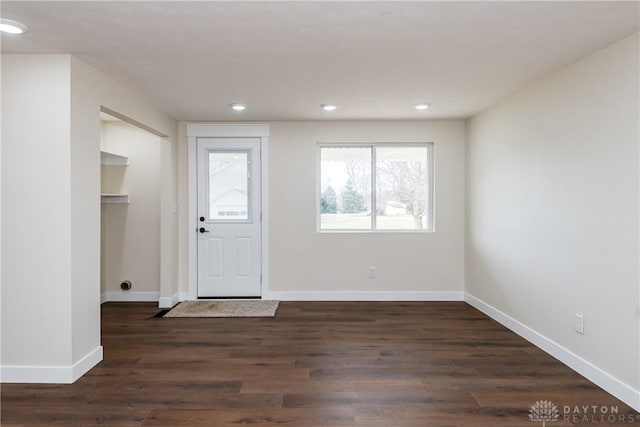 foyer with dark wood-style floors, baseboards, and recessed lighting