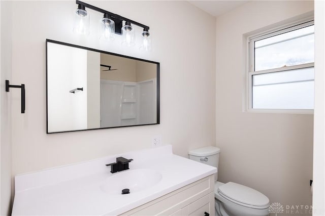 bathroom featuring toilet and vanity