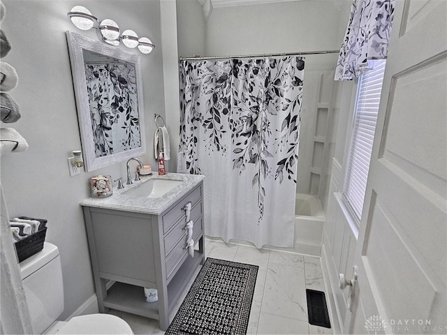 full bathroom featuring visible vents, toilet, shower / tub combo with curtain, marble finish floor, and vanity