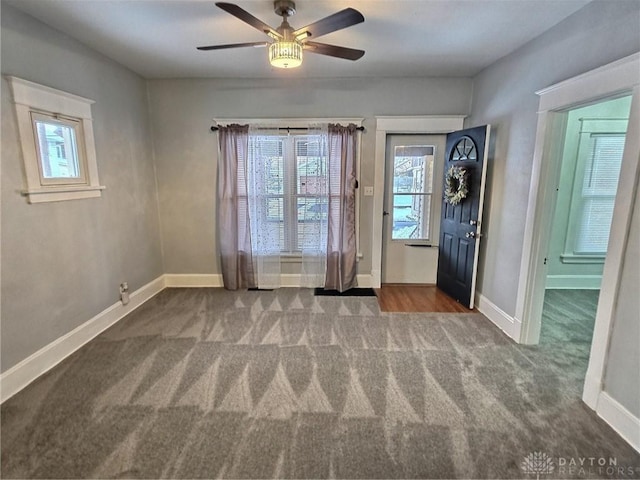 doorway to outside with carpet, baseboards, and a ceiling fan