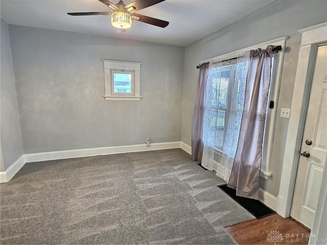 empty room with a ceiling fan, carpet flooring, and baseboards