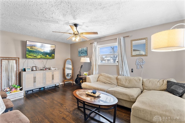 living area featuring ceiling fan, dark wood-style flooring, a textured ceiling, and baseboards