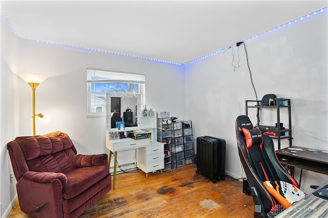 home office with baseboard heating and hardwood / wood-style flooring