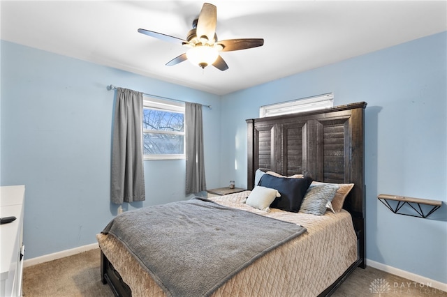 bedroom with ceiling fan, carpet floors, and baseboards