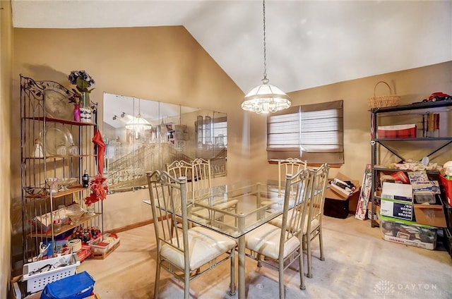 dining space with high vaulted ceiling