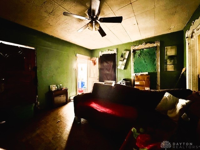 living area featuring a ceiling fan