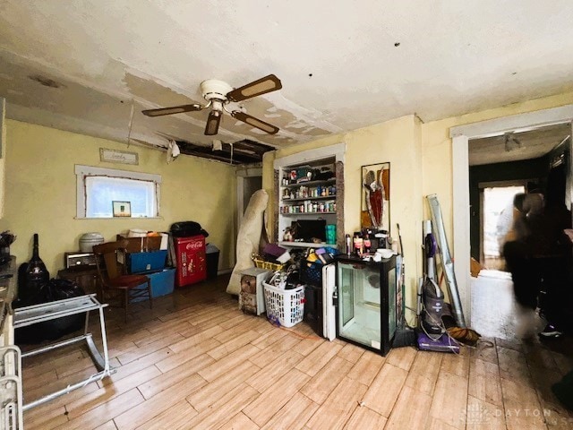 misc room with light wood-style flooring and ceiling fan