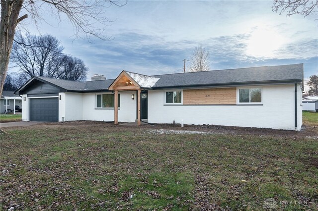 single story home with a garage, driveway, a shingled roof, a chimney, and a front yard