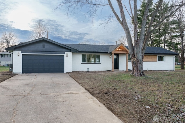 ranch-style home with concrete driveway and an attached garage