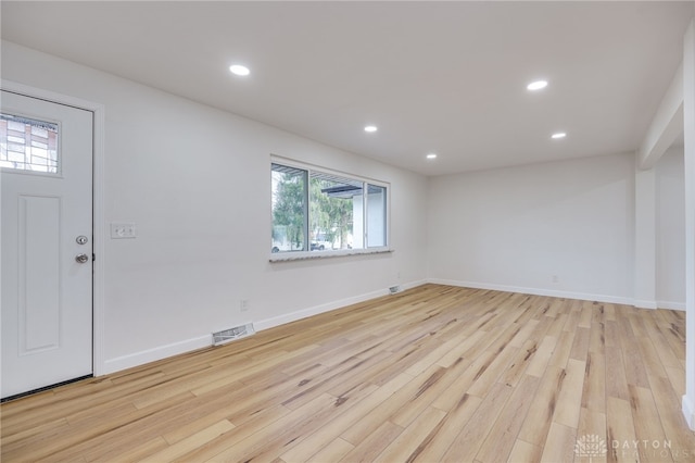 entryway with light wood-type flooring, visible vents, baseboards, and recessed lighting