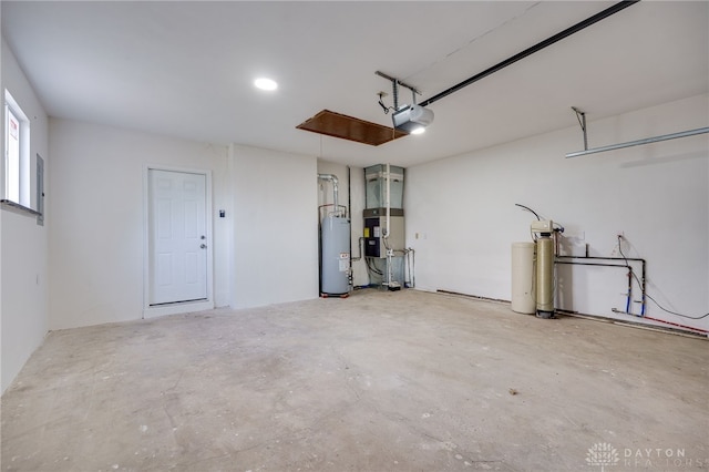 garage with a garage door opener and water heater