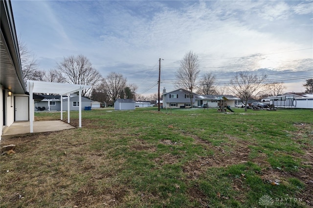 view of yard with a patio area, a residential view, and a pergola