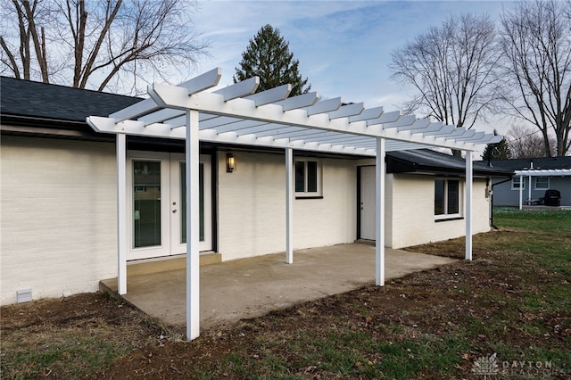 back of property with a standing seam roof, brick siding, crawl space, and a pergola