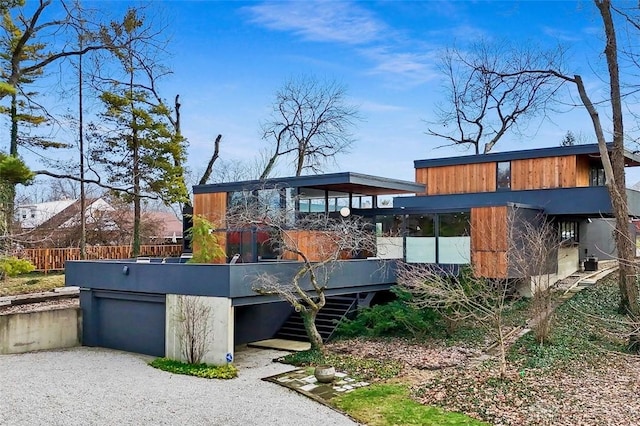 contemporary house with a garage and gravel driveway